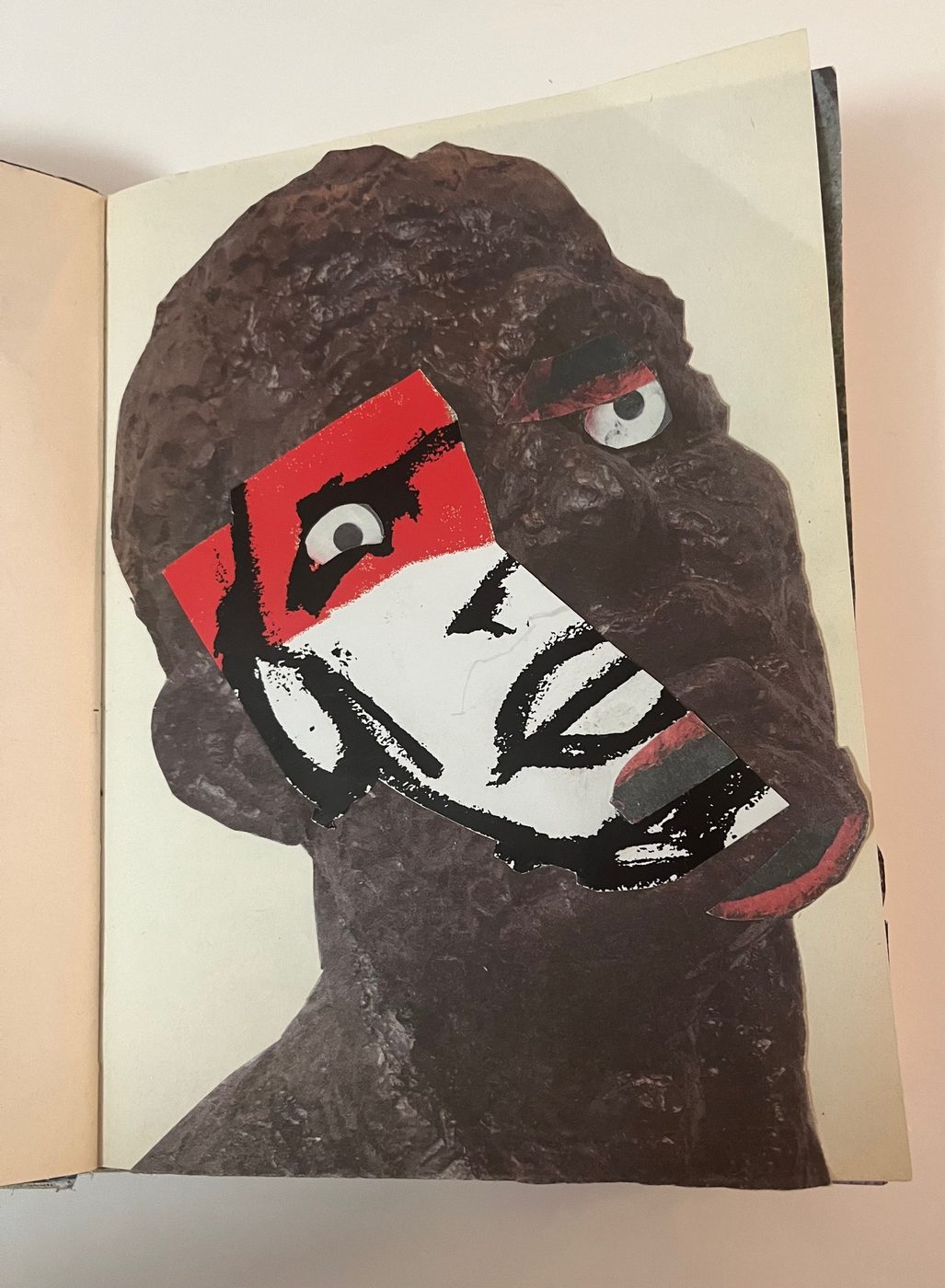 Original notebook
              collage: a sculpted head photograph with a magazine-cut
              crayon drawing overlaid as a mask on the face.